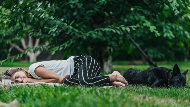 Woman relaxing with dog