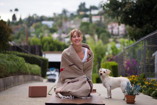 Woman doing yoga with a dog